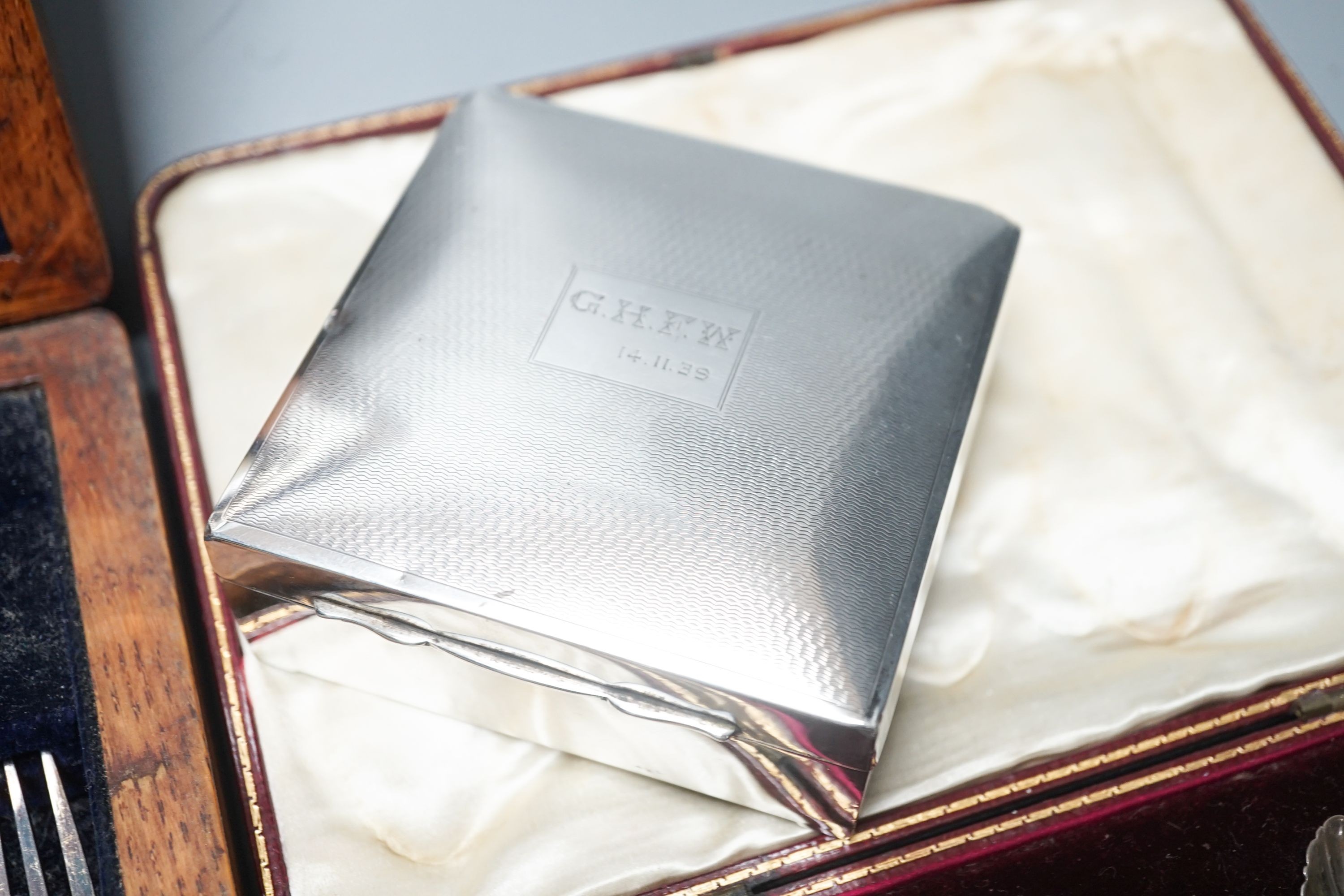 A cased set of silver teaspoons and tongs, a silver mounted cigarette case and plated part dessert service